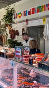 A man works behind a market stall in Portugal